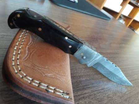 Handmade Damascus steel folding knife with BULL Horn handle scales
