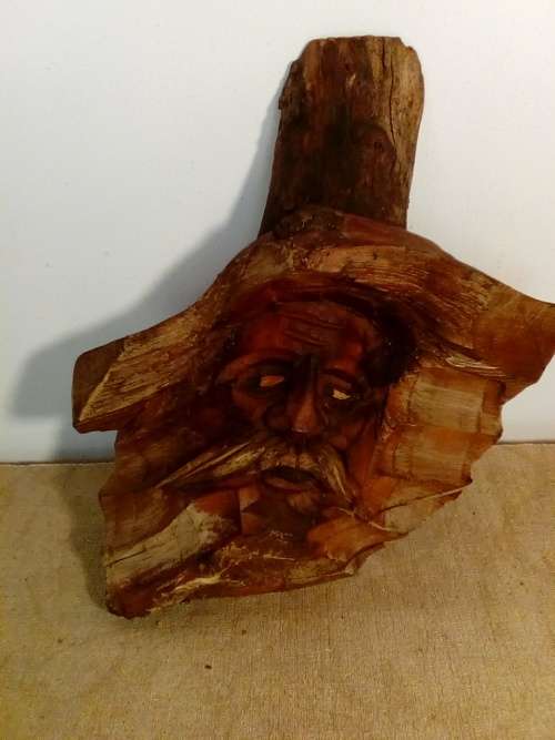 Face carved from raw wood Wall Hanging