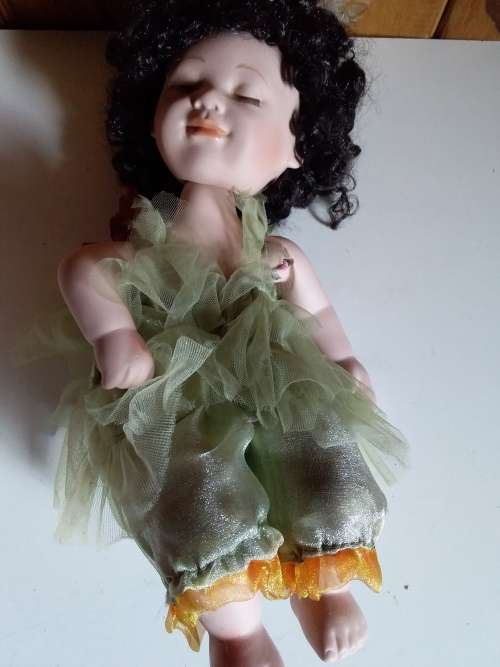 Ceramic doll with closed eyes