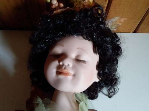 Ceramic doll with closed eyes