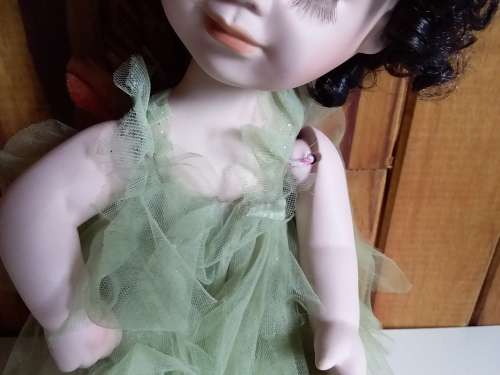 Ceramic doll with closed eyes
