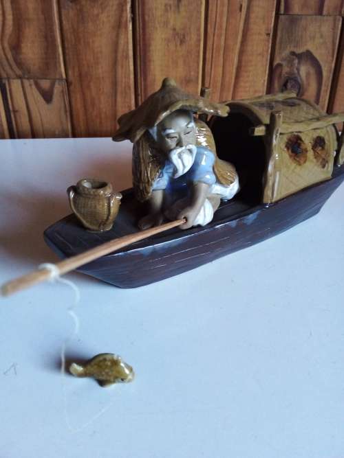Vintage Partially Glazed Clay Oriental Fisherman in Boat