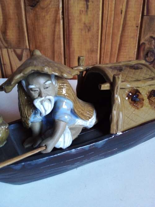 Vintage Partially Glazed Clay Oriental Fisherman in Boat