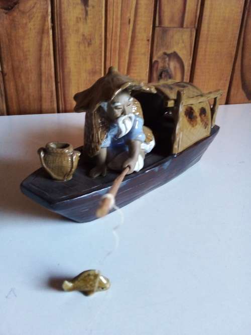 Vintage Partially Glazed Clay Oriental Fisherman in Boat