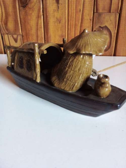 Vintage Partially Glazed Clay Oriental Fisherman in Boat