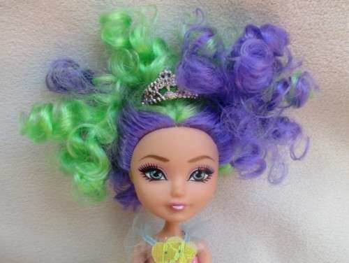 A PRETTY  CURLY HEADED FASHION DOLL IN MERMAID'S COSTUME