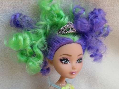 A PRETTY  CURLY HEADED FASHION DOLL IN MERMAID'S COSTUME