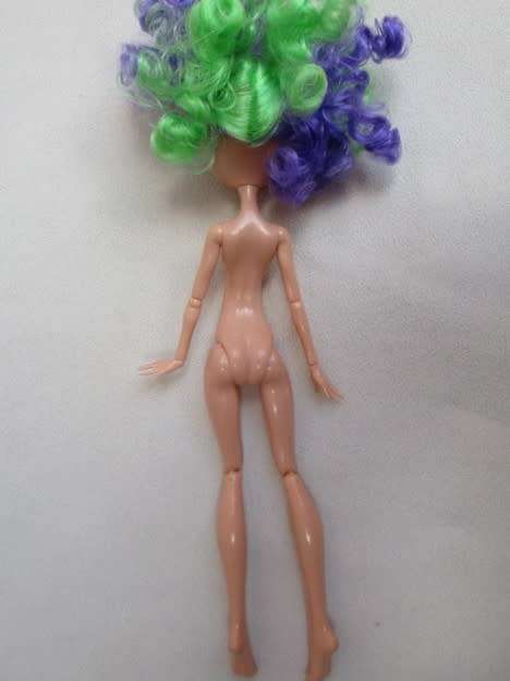 A PRETTY  CURLY HEADED FASHION DOLL IN MERMAID'S COSTUME