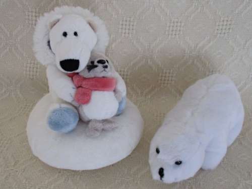 A NICI POLAR BEAR HOLDING A BABY SEAL AND HIS WIMPY POLAR BEAR FRIEND