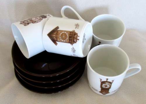 FOUR MITTERTEICH COFFEE CUPS AND SAUCERS - HOLLAND CLOCK DESIGN NO'S 1 TO 4