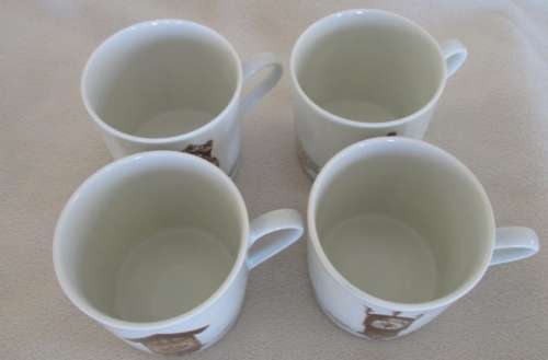 FOUR MITTERTEICH COFFEE CUPS AND SAUCERS - HOLLAND CLOCK DESIGN NO'S 1 TO 4