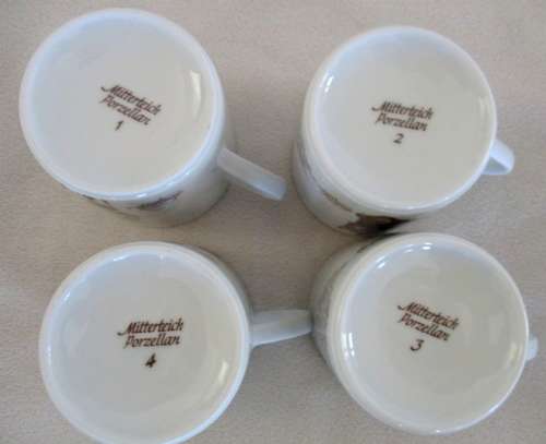 FOUR MITTERTEICH COFFEE CUPS AND SAUCERS - HOLLAND CLOCK DESIGN NO'S 1 TO 4