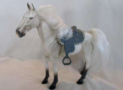 A GORGEOUS HARD PLASTIC HORSE WITH SADDLE