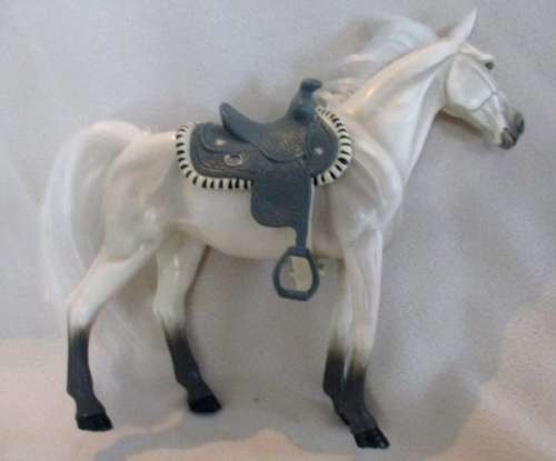 A GORGEOUS HARD PLASTIC HORSE WITH SADDLE