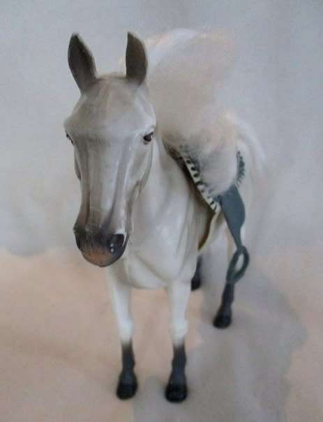 A GORGEOUS HARD PLASTIC HORSE WITH SADDLE