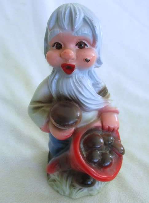 A VERY OLD 19CM TALL VINTAGE HARD RUBBER GNOME CARRYING A CORNUCOPIA OF MUSHROOMS!!