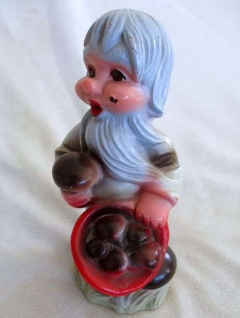 A VERY OLD 19CM TALL VINTAGE HARD RUBBER GNOME CARRYING A CORNUCOPIA OF MUSHROOMS!!