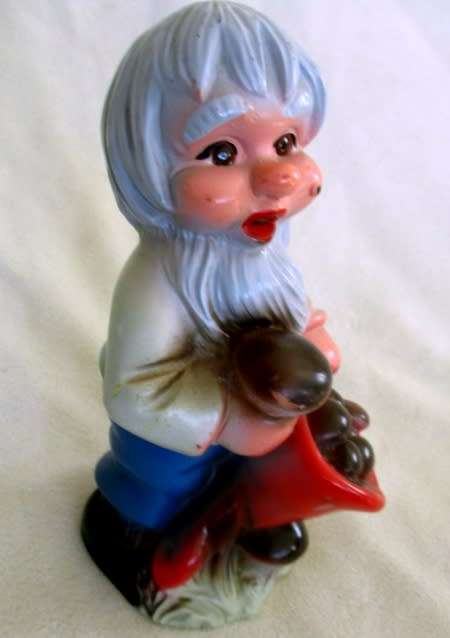 A VERY OLD 19CM TALL VINTAGE HARD RUBBER GNOME CARRYING A CORNUCOPIA OF MUSHROOMS!!