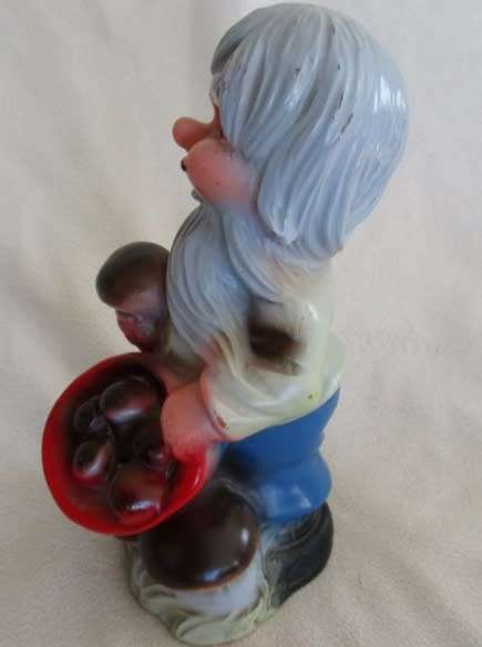 A VERY OLD 19CM TALL VINTAGE HARD RUBBER GNOME CARRYING A CORNUCOPIA OF MUSHROOMS!!