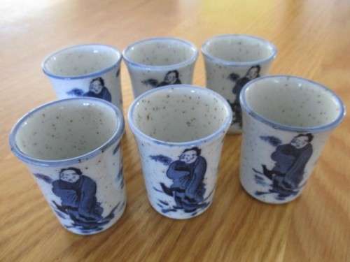 SEVEN PIECE ORIENTAL SAKE SET - SIGNED ON BASE