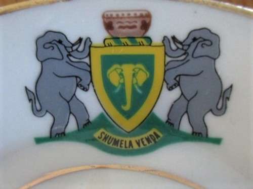 VINTAGE AND HISTORICAL - FORMER HOMELAND VENDA CUP AND SAUCER DEPICTING VENDA COAT OF ARMS