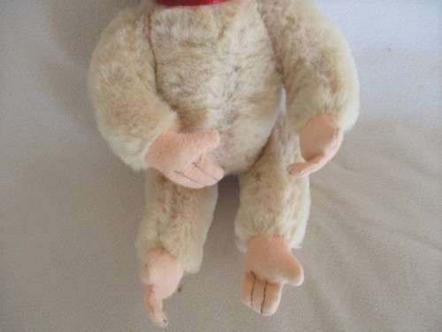 A VINTAGE 1950's/60's FULLY JOINTED MOHAIR RUBBER-FACED SCHUCO MONKEY WITH FELT EARS AND SQUEAKER