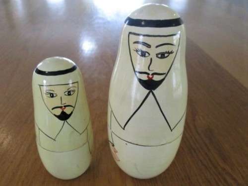 AN UNUSUAL FOUR PIECE HAND PAINTED MATRYOSHKA/BABUSHKA NESTING DOLL SET