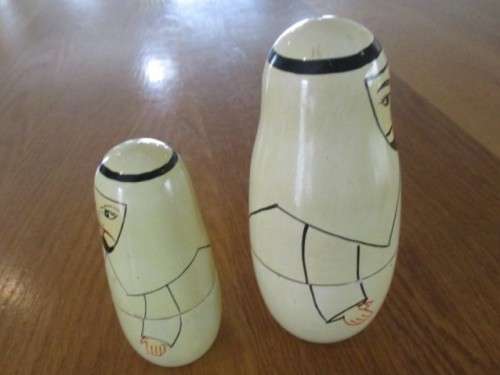 AN UNUSUAL FOUR PIECE HAND PAINTED MATRYOSHKA/BABUSHKA NESTING DOLL SET