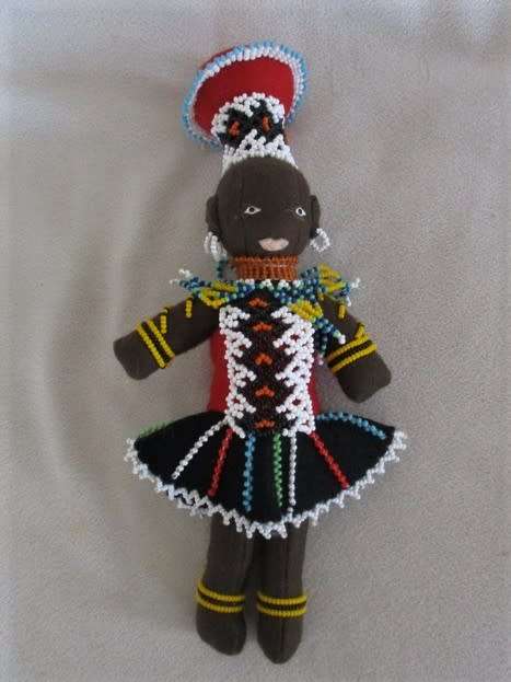 A SMALL VINTAGE HAND MADE TRADITIONAL ZULU BLACK CLOTH DOLL WITH INTRICATE BEADWORK