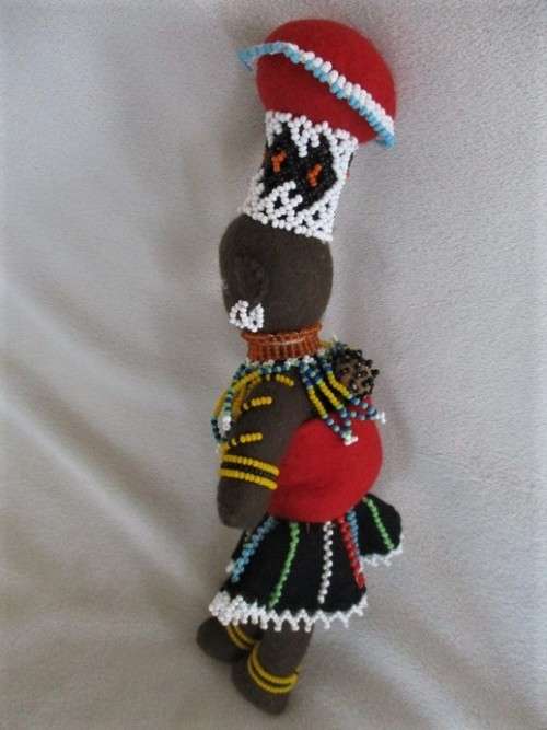 A SMALL VINTAGE HAND MADE TRADITIONAL ZULU BLACK CLOTH DOLL WITH INTRICATE BEADWORK