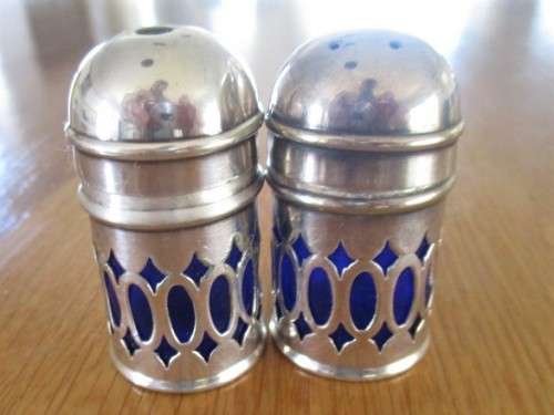 SALT AND PEPPER SET WITH BLUE GLASS INNERS (PLEASE DISREGARD REFLECTIONS)