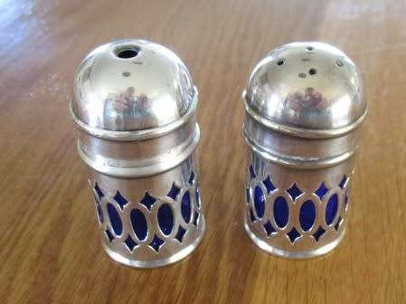 SALT AND PEPPER SET WITH BLUE GLASS INNERS (PLEASE DISREGARD REFLECTIONS)