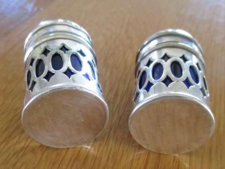 SALT AND PEPPER SET WITH BLUE GLASS INNERS (PLEASE DISREGARD REFLECTIONS)