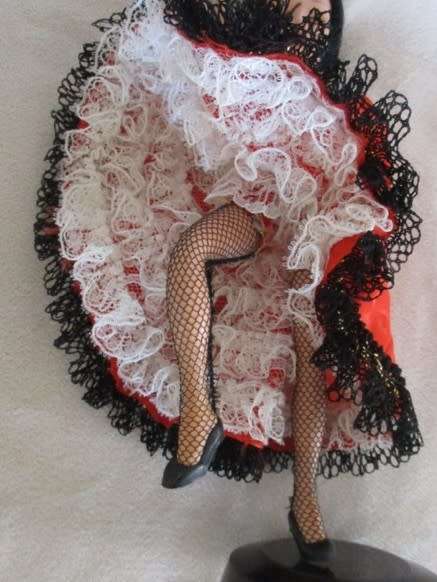 A PRETTY SMALL VINTAGE CAN-CAN DOLL ON STAND