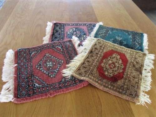 A SET OF FOUR HAND WOVEN PERSIAN PLACE MATS
