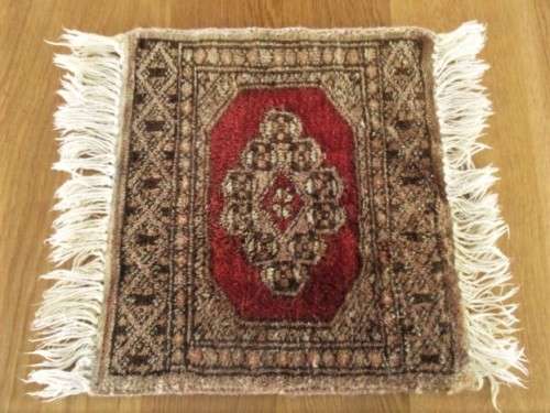 A SET OF FOUR HAND WOVEN PERSIAN PLACE MATS
