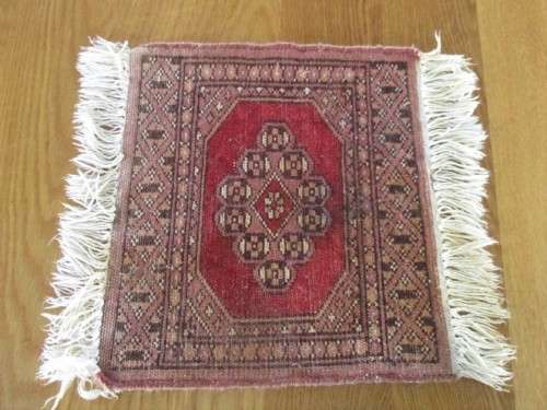 A SET OF FOUR HAND WOVEN PERSIAN PLACE MATS