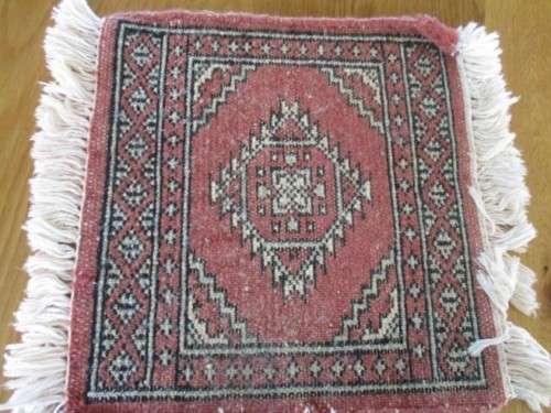 A SET OF FOUR HAND WOVEN PERSIAN PLACE MATS