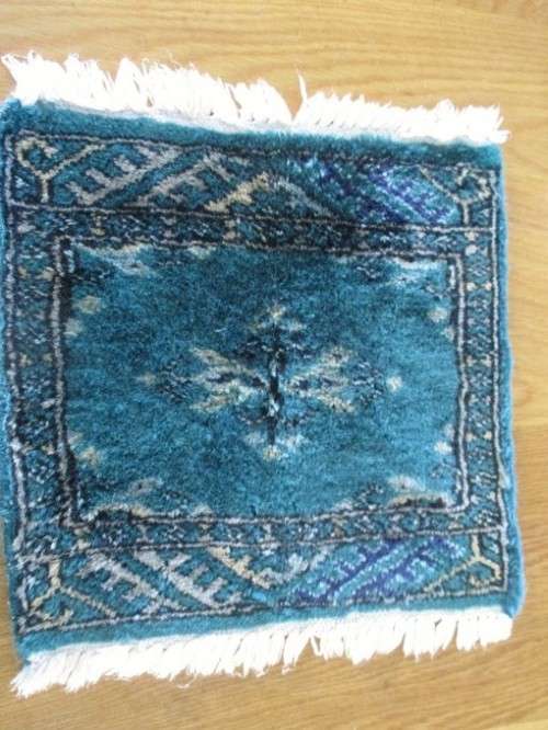 A SET OF FOUR HAND WOVEN PERSIAN PLACE MATS