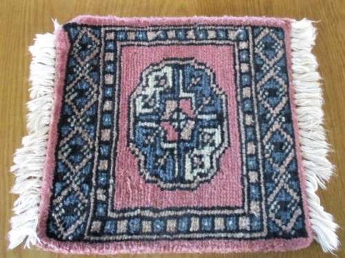 A SET OF FOUR HAND WOVEN PERSIAN PLACE MATS