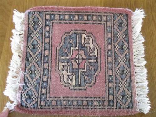 A SET OF FOUR HAND WOVEN PERSIAN PLACE MATS