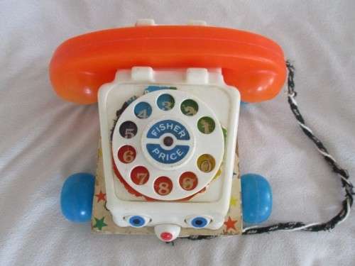 A VINTAGE 1960's FISHER PRICE PULL ALONG TELEPJONE WITH WOODEN BASE