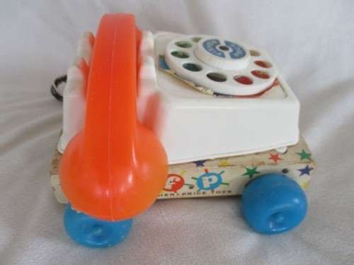 A VINTAGE 1960's FISHER PRICE PULL ALONG TELEPJONE WITH WOODEN BASE
