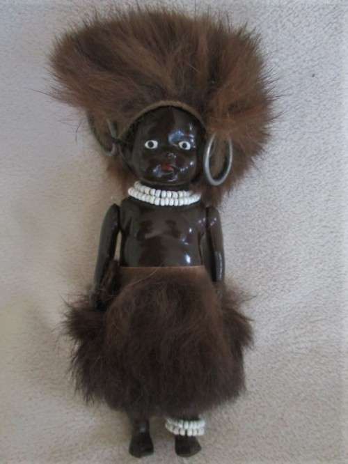 A SMALL VINTAGE CELLULOID BLACK DOLL IN TRADITIONAL ZULU GARB MADE IN SOUTH AFRICA