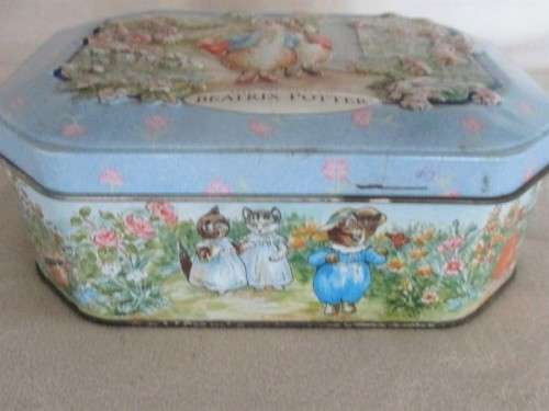 A COLLECTABLE BENTLEY'S OF LONDON TIN WITH RAISED RELIEF DESIGN - THE WORLD OF BEATRIX POTTER