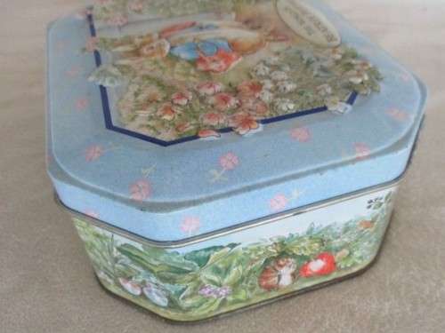 A COLLECTABLE BENTLEY'S OF LONDON TIN WITH RAISED RELIEF DESIGN - THE WORLD OF BEATRIX POTTER