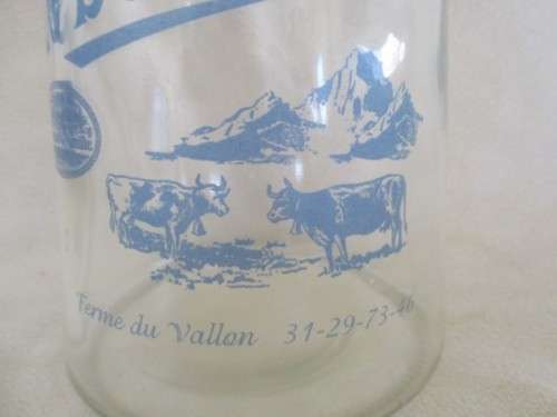 A DECORATIVE VINTAGE FRENCH MILK BOTTLE
