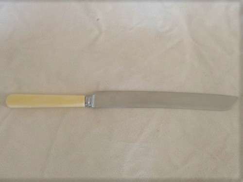 A LARGE VINTAGE BREAD KNIFE MARKED "SHEFFIELD ENGLAND"