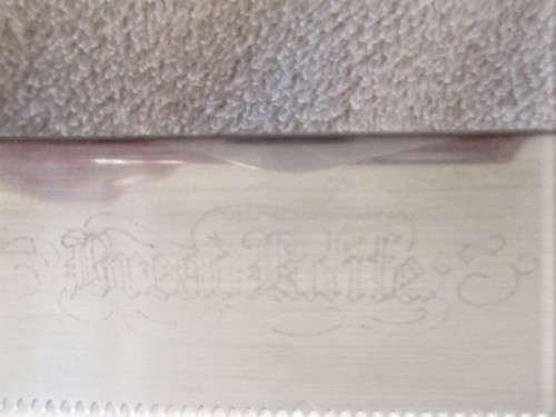 A LARGE VINTAGE BREAD KNIFE MARKED "SHEFFIELD ENGLAND"