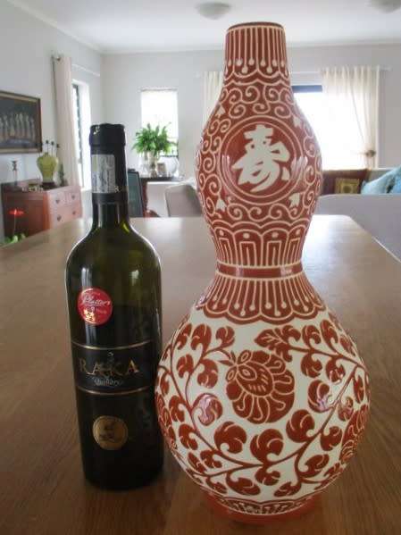 LARGE CORAL RED CHINESE DOUBLE GOURD VASE WITH CHINESE SYMBOLS AND FLORAL DESIGN - SIGNED